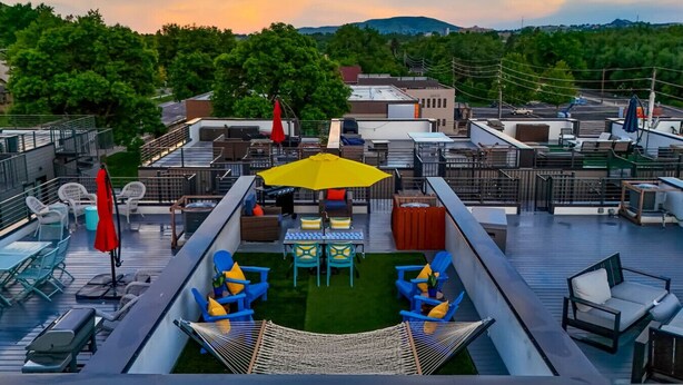 A rooftop terrace with outdoor seating, a hammock, and a view of the surrounding landscape. - Million $ Rooftop MTN Views -2 King Beds-DT Golden (Golden)