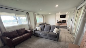 A living room with two sofas, a coffee table, and a TV.
