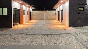 A modern building with a central courtyard, featuring a symmetrical design with two wings and a central open space. - Residencial Fe y Esperanza (Pedernales)