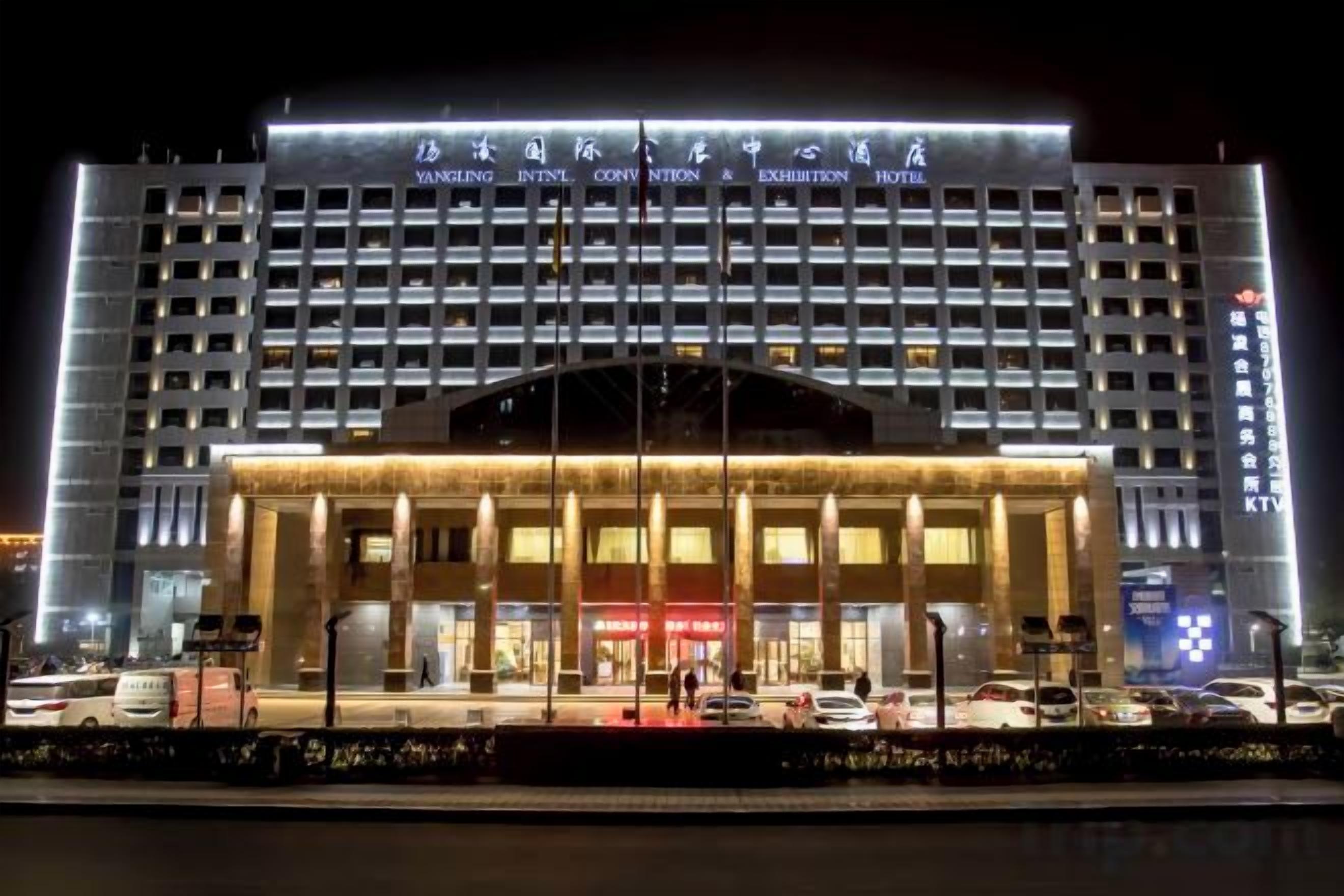 A multi-story hotel with a prominent entrance and signage for an exhibition.