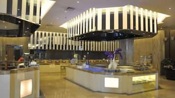 A modern hotel lobby with a central reception desk, a large black and white striped ceiling design, and a marble floor.