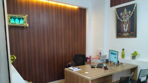 A modern office with a wooden desk, computer, and two chairs. - Urban Elite Apart Hotel  (Hubli)
