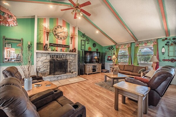 A cozy living room with a fireplace, comfortable seating, and a television.