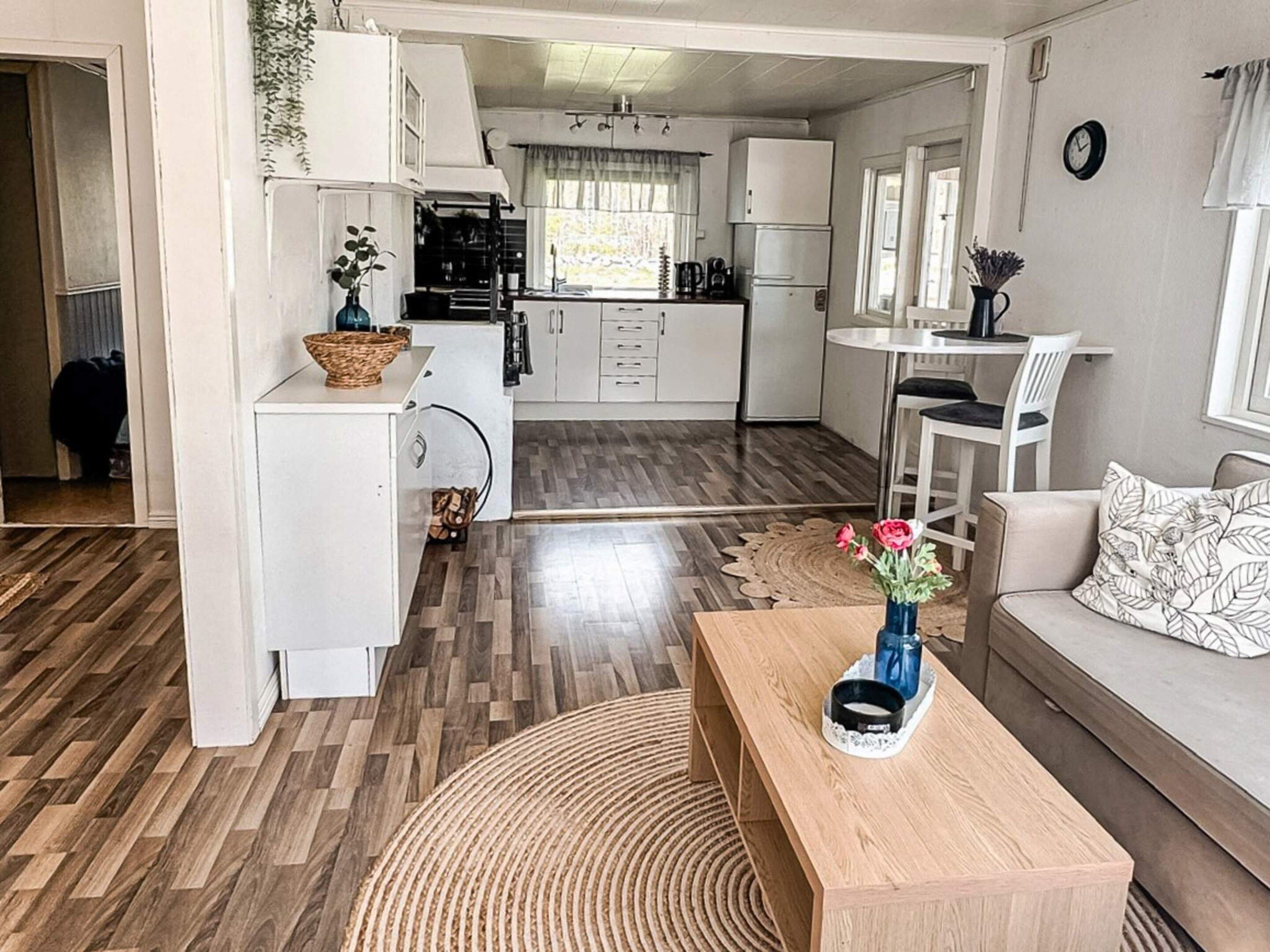 A compact living space with a kitchenette, a dining area, and a seating area with a coffee table.