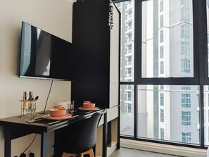 Suite studio, vue sur la ville | Aire de séjour | Téléviseur