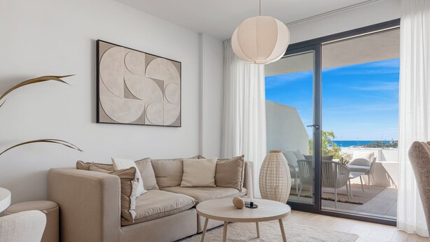 A modern living room with a beige sofa, a round coffee table, and a large abstract painting. - Estepona Beach Getaway! 2BR Apartment (Estepona)