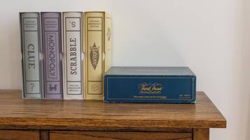 A wooden dresser with vintage books and a box of cigarettes.