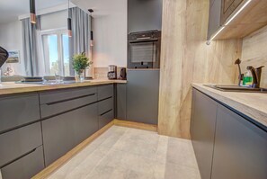 Departamento Confort | Cocina privada | Refrigerador con congelador, parrilla de estufa y lavavajillas 