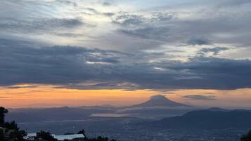 A panoramic view of a cityscape with a mountain in the background.