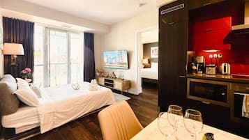 Business Apartment | Living area | 40-inch Smart TV with cable channels