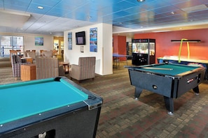 A pool table, another pool table, and a billiards table in a room with a carpeted floor and a blue ceiling. - Charming 1-bedroom unit in resort with fitness room in Seaside next to boardwalk (Seaside)