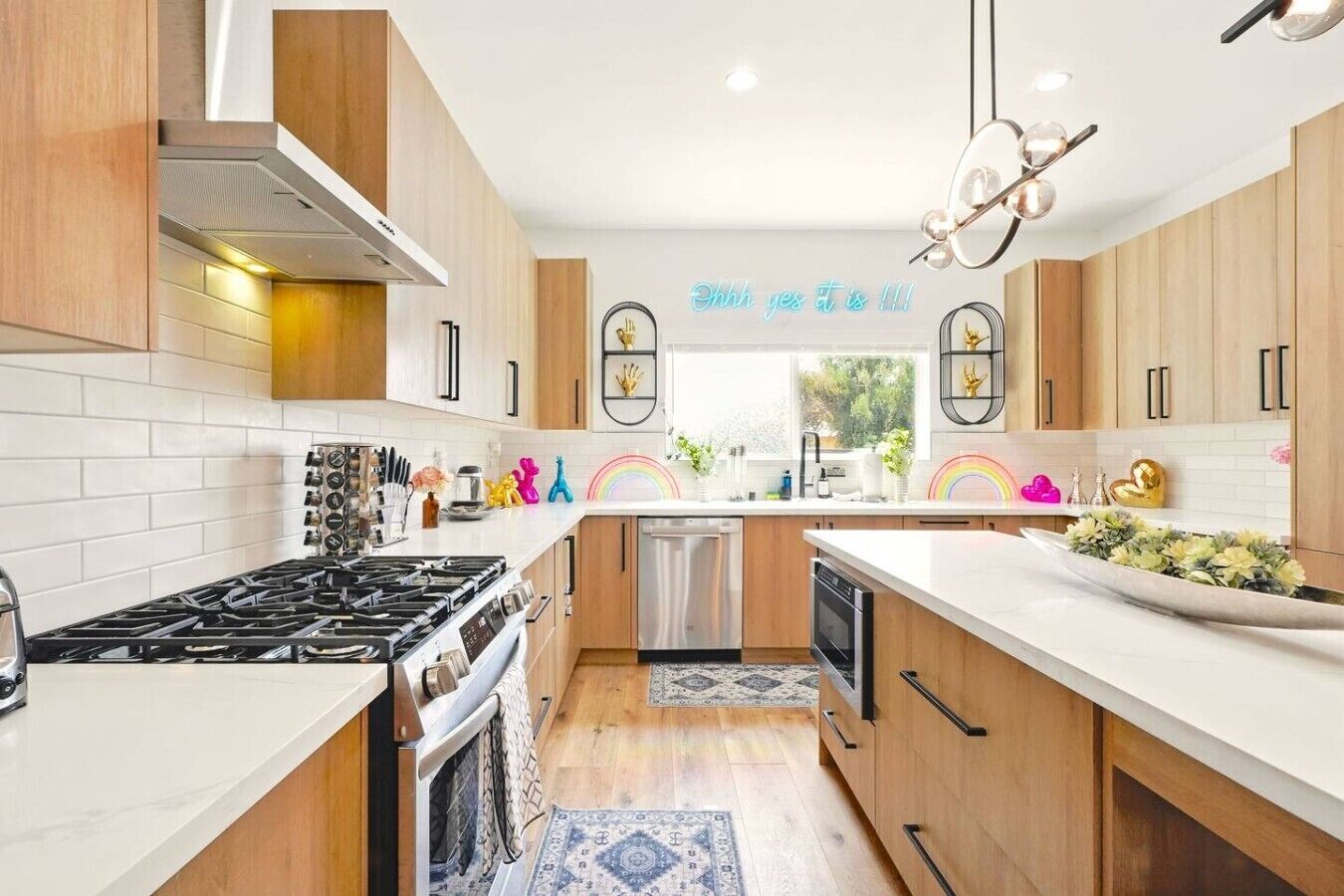 A modern kitchen with wooden cabinets, stainless steel appliances, and a white countertop.