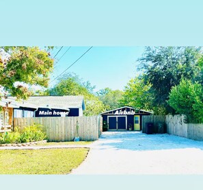 A fenced property with a 'Main house' and an 'Airbnb' building.