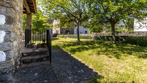 A stone building with a wooden staircase leading to a covered area.
