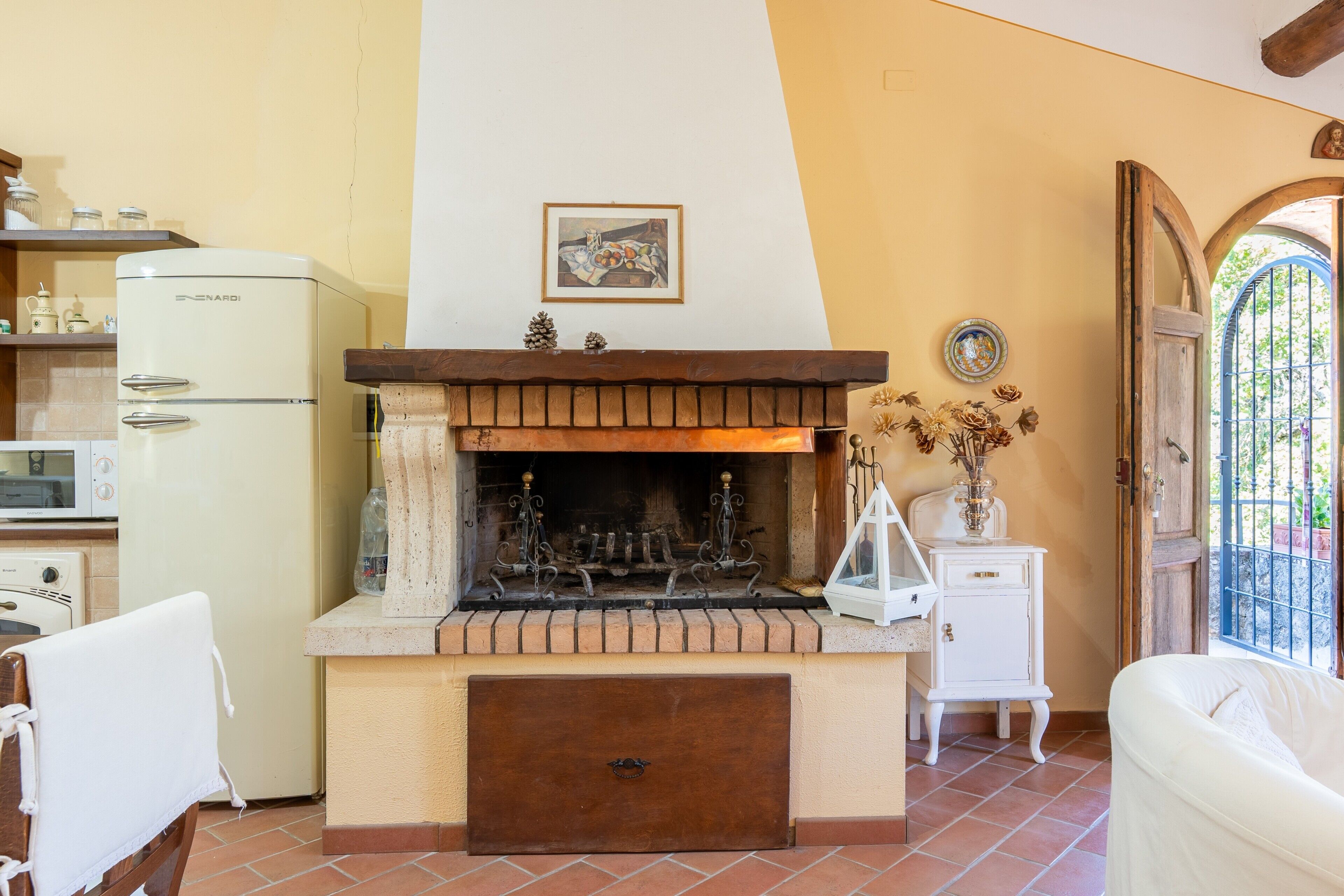 A kitchen with a built-in stove, a microwave, and a refrigerator.