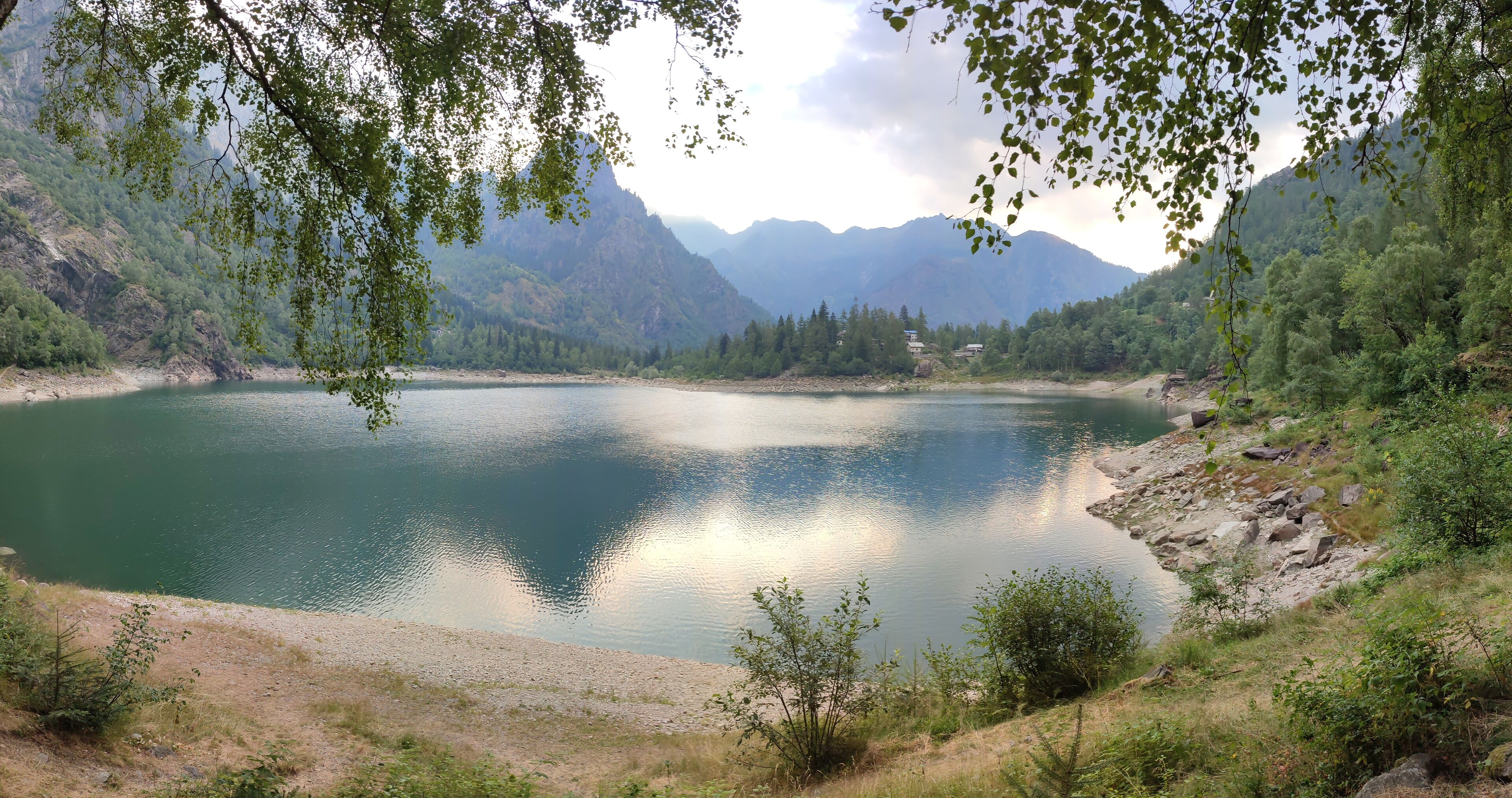 A serene lake surrounded by mountains and trees.