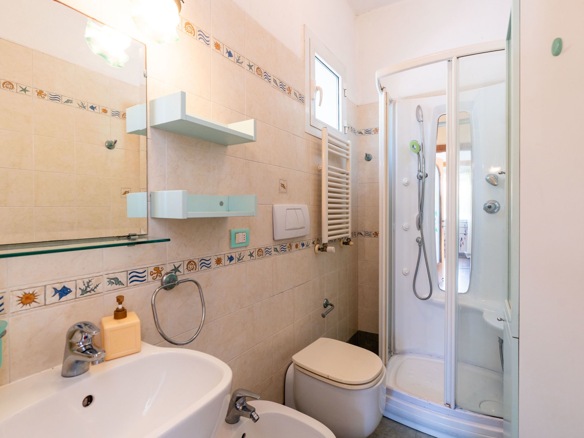 A bathroom with a sink, toilet, and shower.