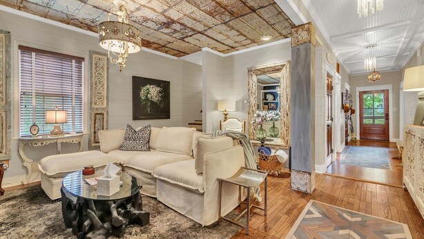 A living room with a sectional sofa, a glass coffee table, and a chandelier. - Family & Friends - Fun In Franklin (Franklin)