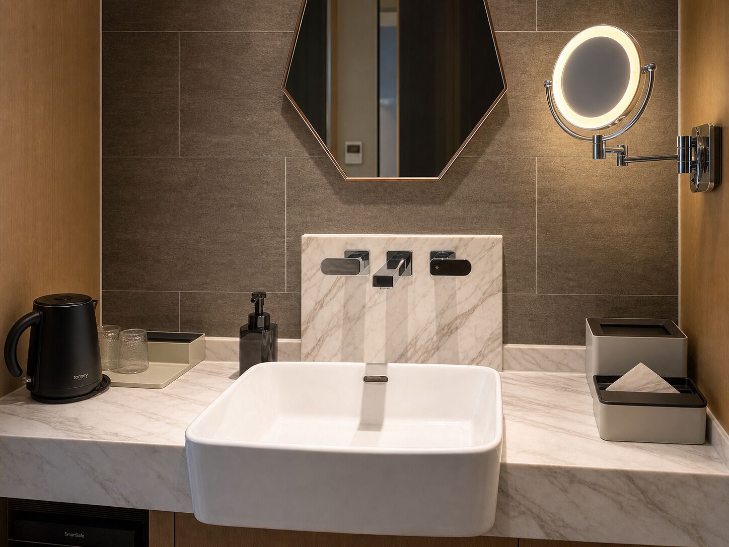 A modern bathroom with a large mirror, a sink, a coffee maker, and a tissue box.