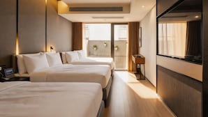 A hotel room with two beds, a TV, a desk, and a balcony with a view. - Atour Hotel Nanjing East Road, Shanghai on the Bund (Shanghai)