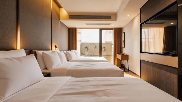 A hotel room with two beds, a large window, a flat-screen TV, and a small table with a chair. - Atour Hotel Nanjing East Road, Shanghai on the Bund (Shanghai)