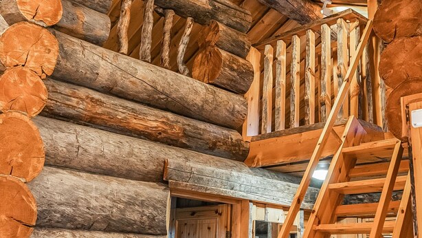 A log cabin interior with a wooden staircase and a loft area. - Rukan pilvimaja by Interhome (Kuusamo)