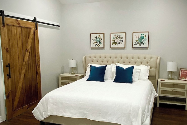 Primary bedroom with California-King sized bed attached spa-like bathroom.