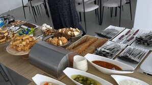 A buffet table with various dishes and condiments. - Bogdon Grand Hotel (Tashkent)