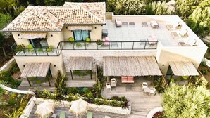 A modern villa with a terrace, outdoor seating, and a pool. - Maison Mahana (Bonifacio)