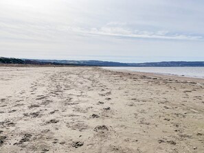 A wide sandy beach with footprints and a calm sea. - 2 Person Holiday Home in Bastad (Bastad)