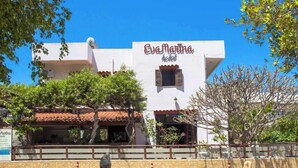 A white building with a sign reading "Eva Marina hotel". - Eva Marina Hotel (Faistos)