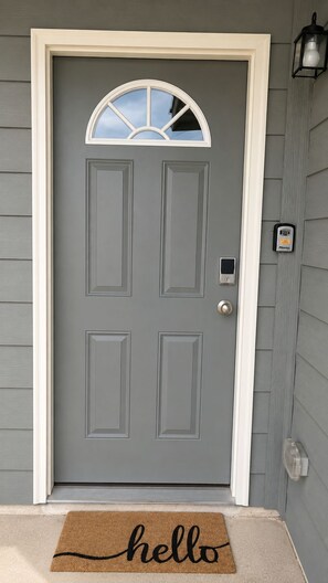 A grey front door with a white frame, a small window above it, a doorbell, and a mailbox on the right. - [HB101] New 3BR w/Parking I Family Friendly & Stocked I Near JBSA Randolph AFB (San Antonio)
