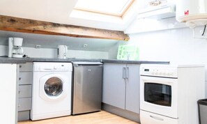 Fridge, microwave, coffee/tea maker, cookware/dishes/utensils