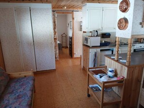 A compact living space with a kitchenette, a dining area, and a bedroom with a sofa. - 5 Person Holiday Home in Lidsjoberg (Lidsjöberg)
