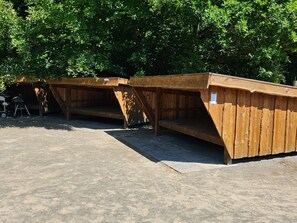 A row of wooden structures with benches, likely for outdoor seating or rest areas. - 1 Person Holiday Park Home in Lemvig (Lemvig)