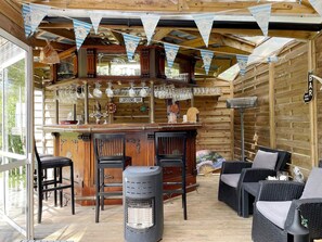 A cozy bar area with wooden walls, a bar counter, and seating. - 5 Star Holiday Home in Graddo (Gräddö)