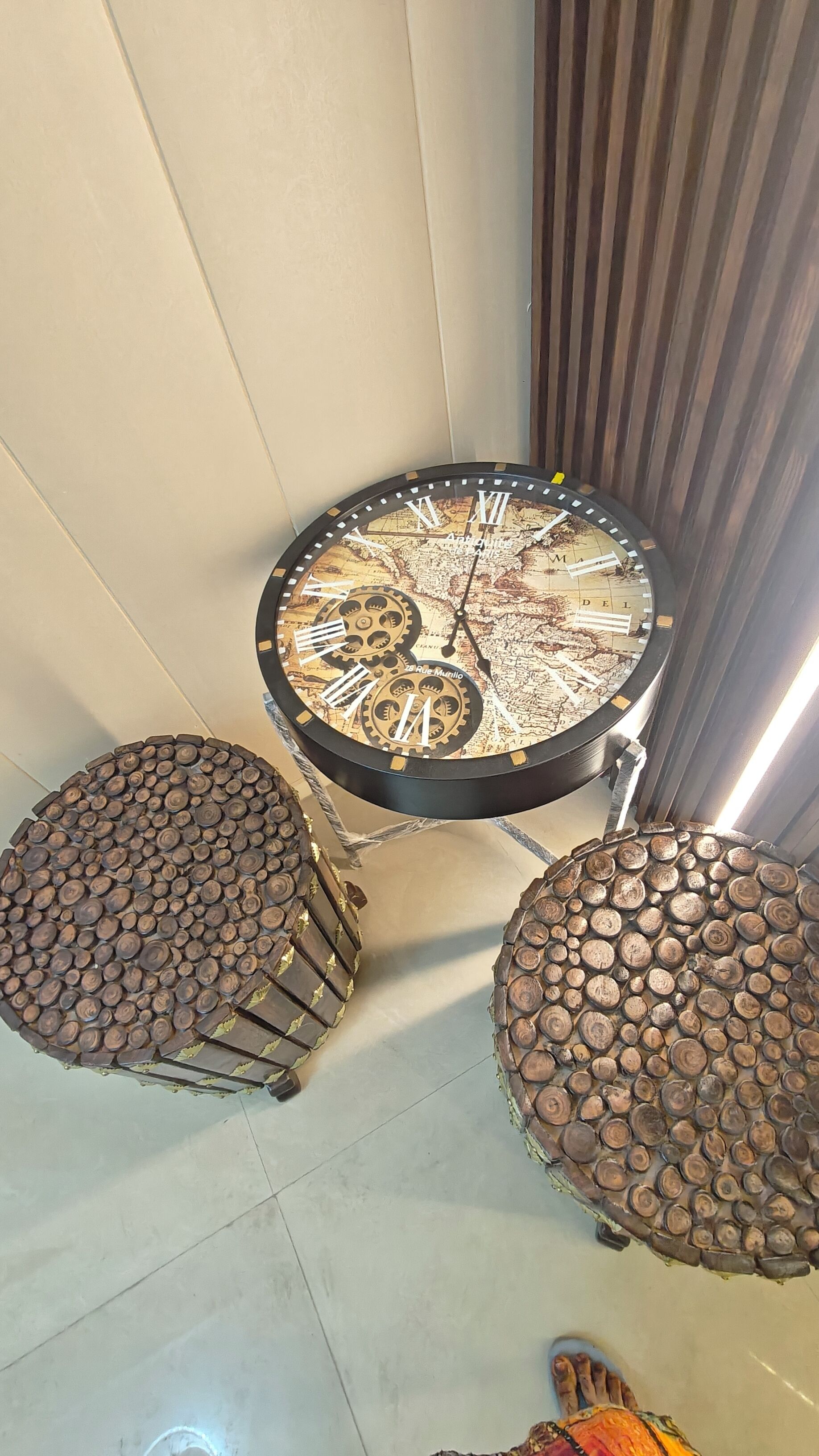 A round table with a map and gears, flanked by two stools made of logs.