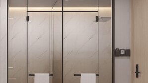 A modern bathroom with a glass partition, a toilet, a bidet, and a towel rack. - Fengdu Hotel (Shanghai Lujiazui Baibaiban Branch) (Shanghai)