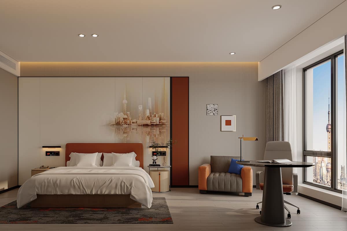 A modern bedroom with a large bed, a desk, and a view of a cityscape.