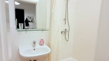 Shower, hair dryer, towels, toilet paper