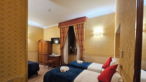 A hotel room with two beds, a desk, a chair, a television, and a wardrobe. - Hotel Amadeus (Rome)