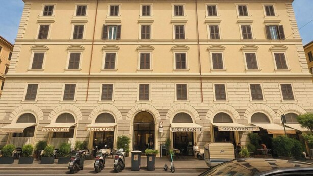 A large, multi-story building with arched windows and multiple 'Ristorante' signs indicating dining areas. - Hotel Amadeus (Rome)