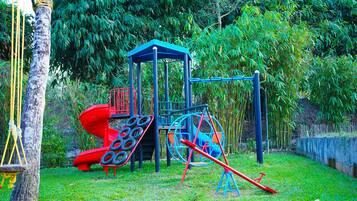 A playground with a slide, swings, and a climbing structure.