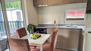 Una cocina moderna con comedor, un ventanal y vistas al exterior.