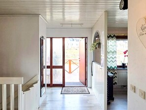 A hallway with a wooden floor leading to a glass door entrance. - 4 Star Holiday Home in Ljusne (Ljusne)