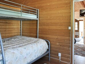 A bunk bed in a wooden room with a visible electrical outlet on the wall. - 4 Star Holiday Home in Kil (Kil)