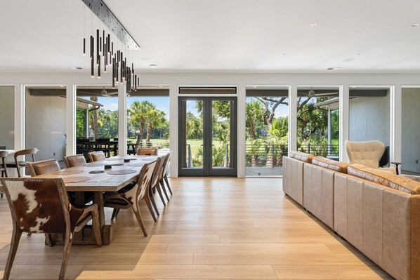 A modern dining area with a wooden table, leather chairs, and a built-in bench along the wall.