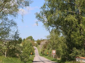 A rural road flanked by trees and vegetation, with a speed limit sign indicating 70 km/h. - 4 Person Holiday Home in Ullared (Ullared)