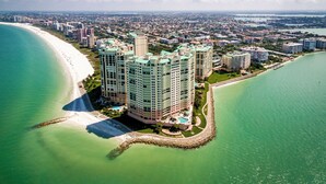 A high-rise hotel with multiple floors, situated by a beach and a body of water. - Elevated Elegance With Gulf Scanning Panorama (Marco Island)