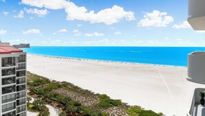 A high-rise hotel overlooking a beach with a clear sky. - Monthly Executive Picturesque Sunset Retreat (Marco Island)